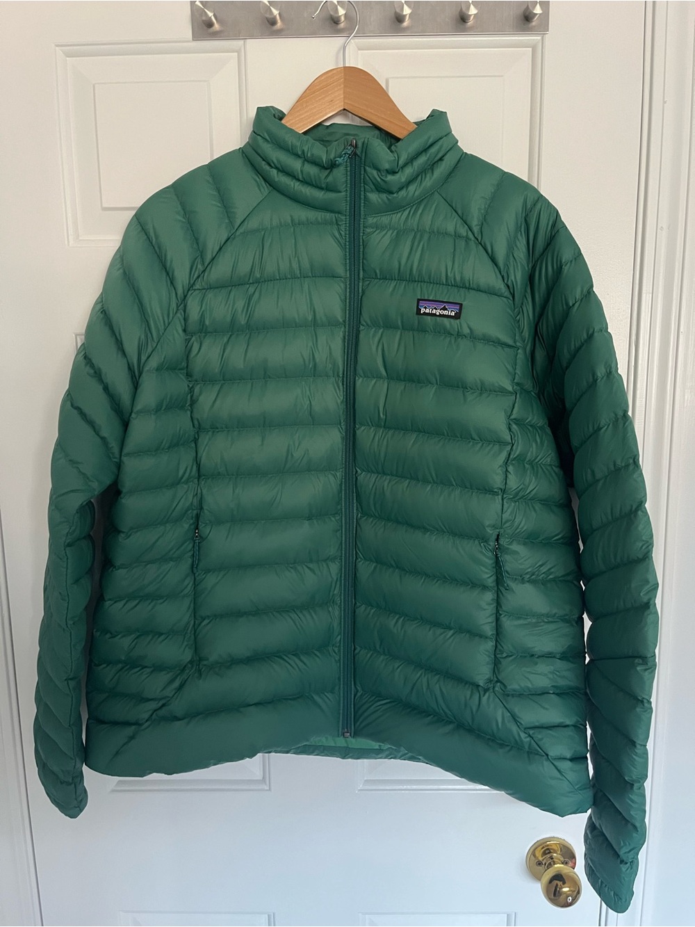 Patagonia puffer jacket in teal green with logo patch